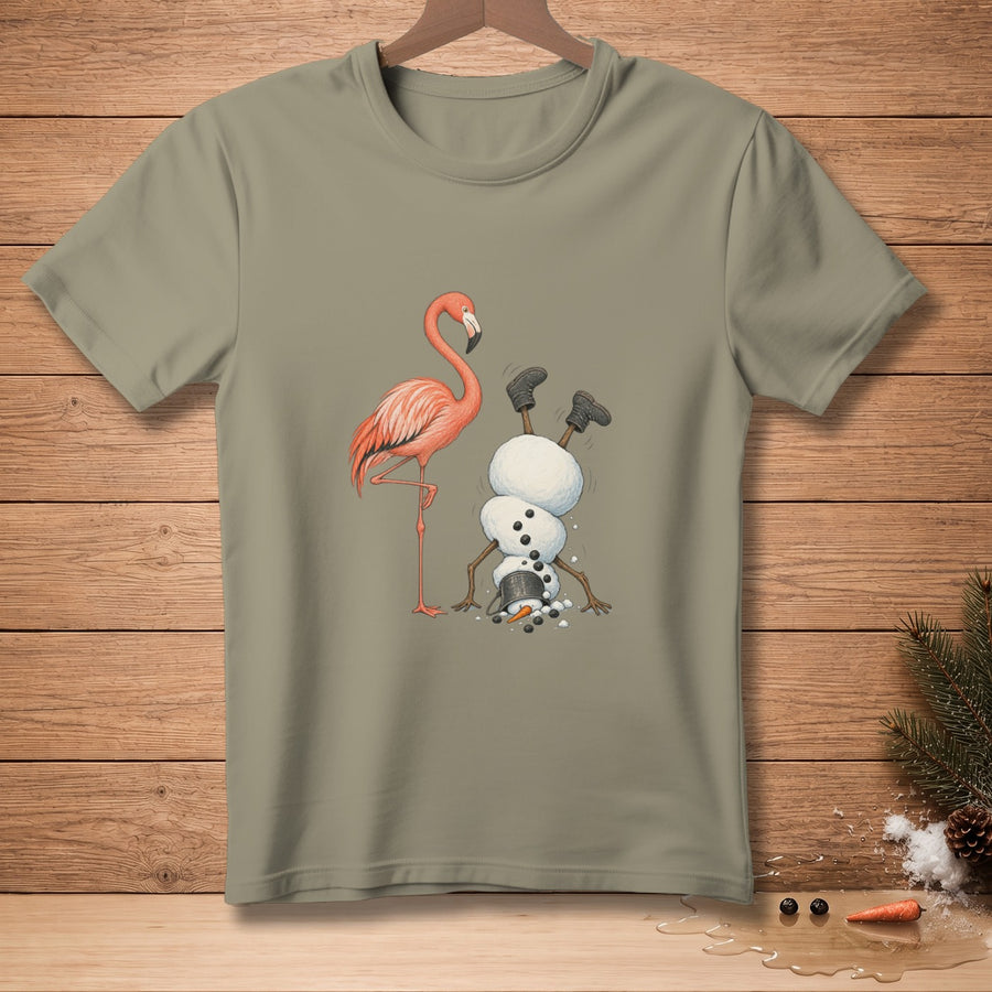 A flamingo stands next to a snowman doing a handstand, with his hat fallen off.