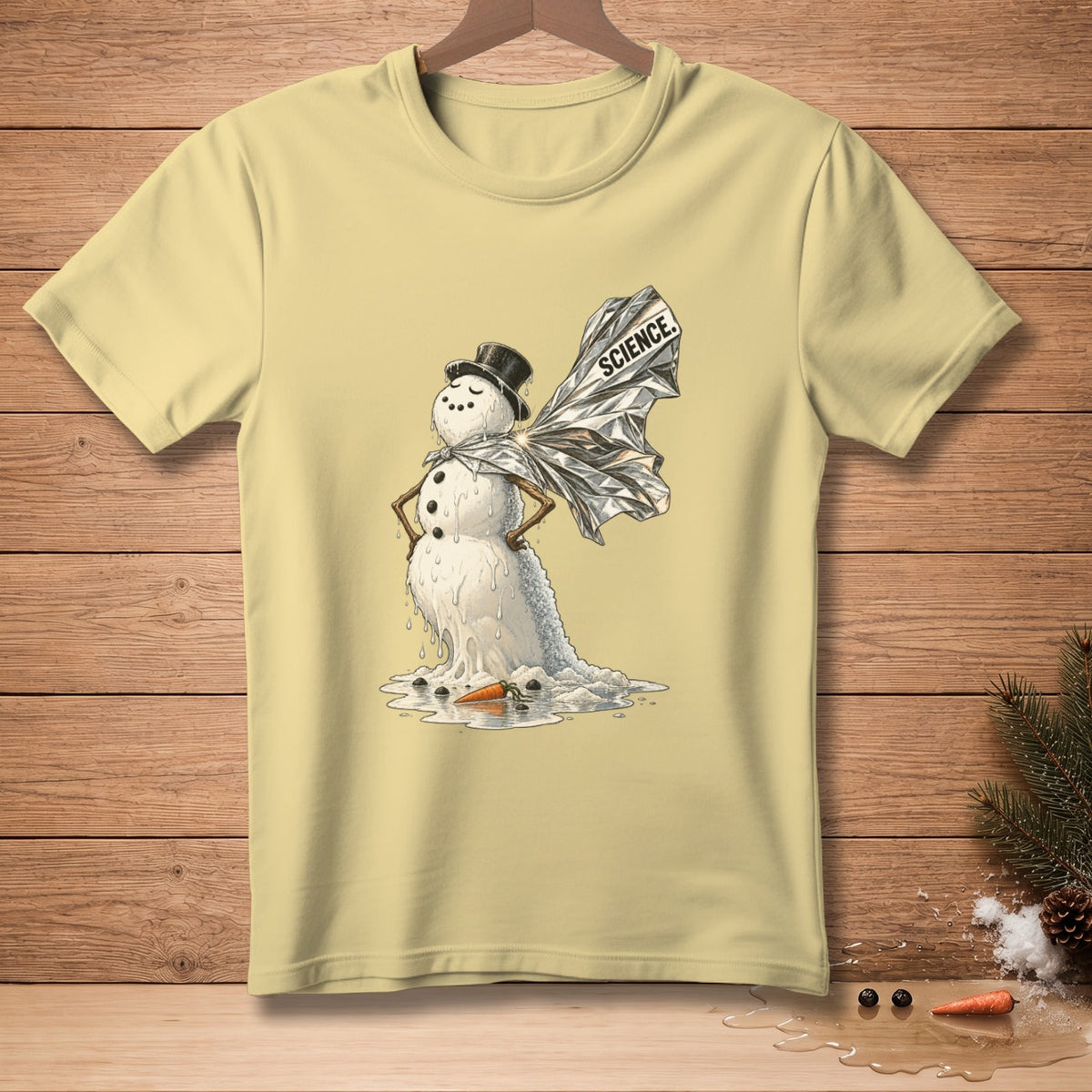 Melting snowman with foil wings that read "SCIENCE" on a pale yellow t-shirt.