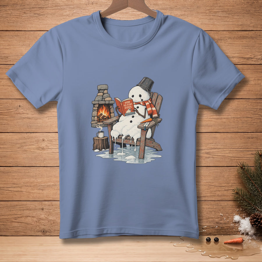 Melting snowman in chair by fireplace reads "How to Stay Cool" book.