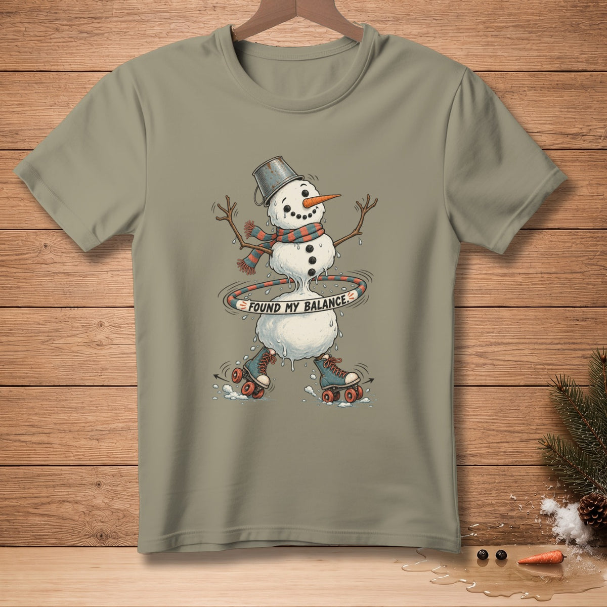 Snowman with bucket hat, scarf, roller skates, and hula hoop that says "FOUND MY BALANCE".