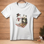 White t-shirt graphic of a melting snowman and panda enjoying a picnic.