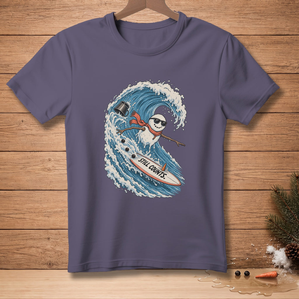 Snowman surfing a wave on a surfboard with "STILL COUNTS." text.