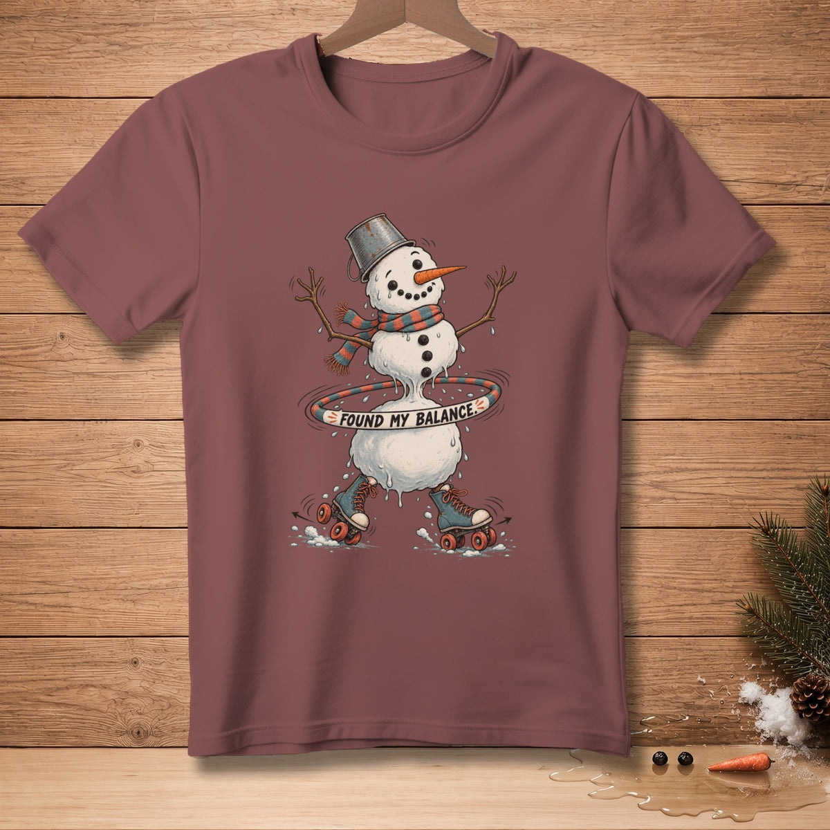 Melting snowman on roller skates with a hula hoop, text reads "FOUND MY BALANCE."