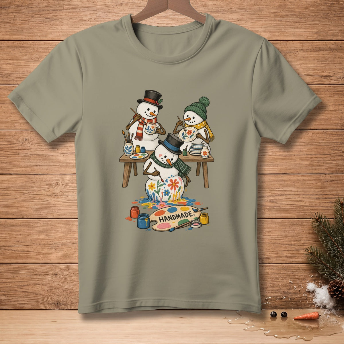 Three snowmen painting flowers on a palette with "HANDMADE" text.