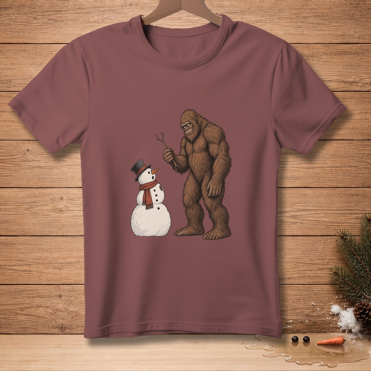 Bigfoot holds stick near snowman wearing a top hat and scarf.