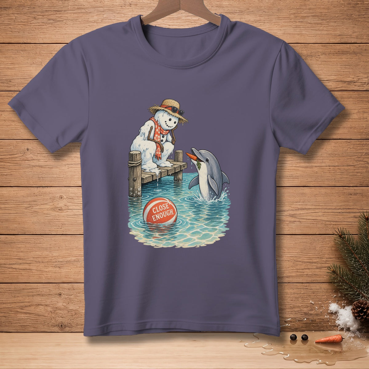 Melting snowman on a pier with a dolphin, holding a carrot, with a ball that reads "CLOSE ENOUGH".