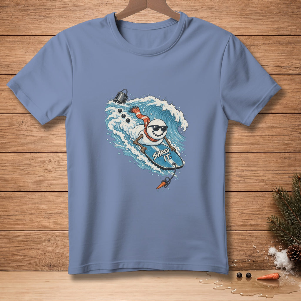 Snowman wearing sunglasses and scarf surfing a wave, text "SHRED IT."