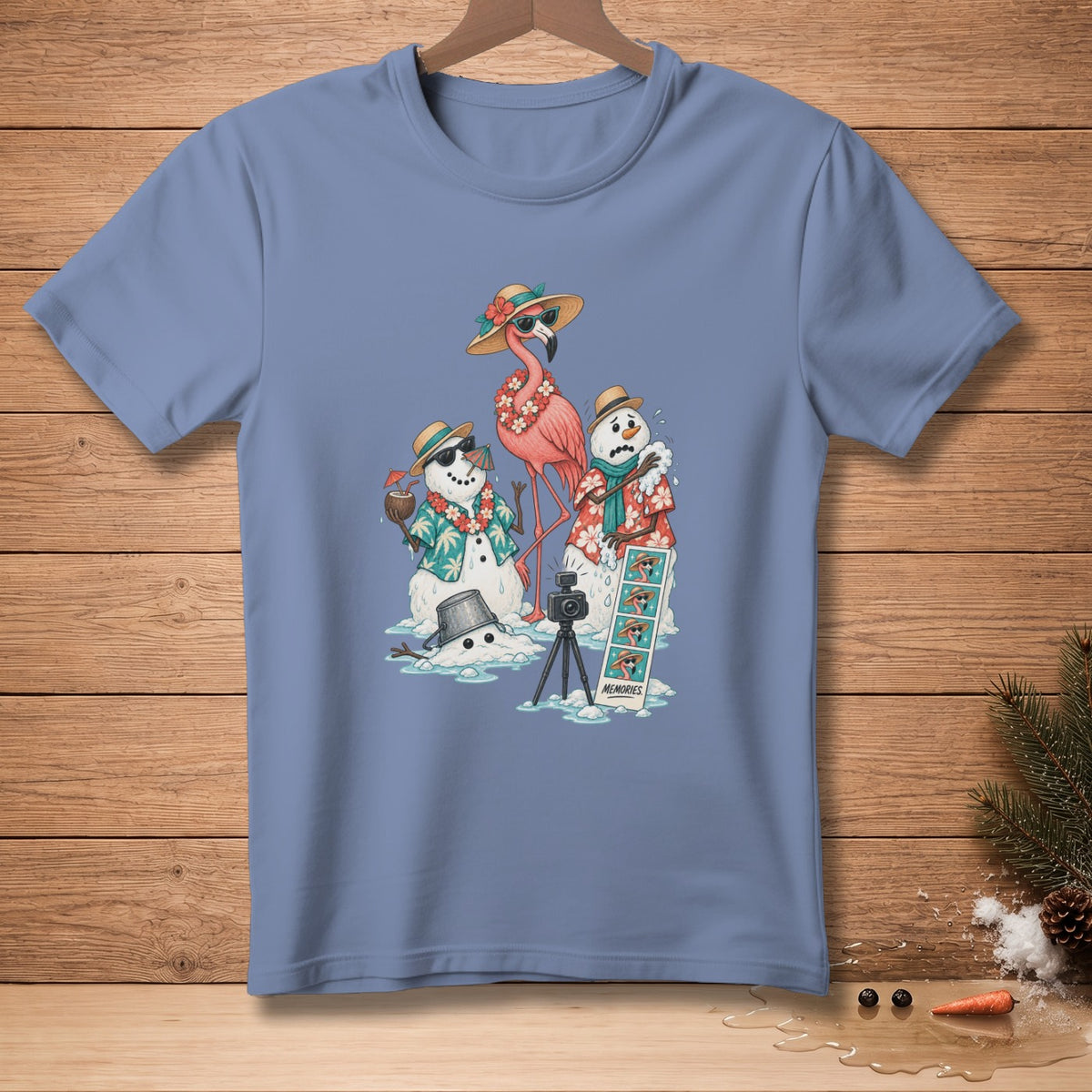 T-shirt graphic: melting snowmen, flamingo, camera, and "Memories" photo strip.