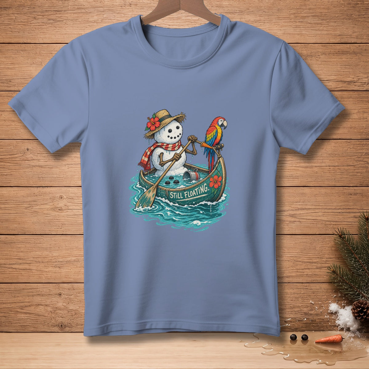 Snowman in a canoe with a parrot, text "STILL FLOATING".