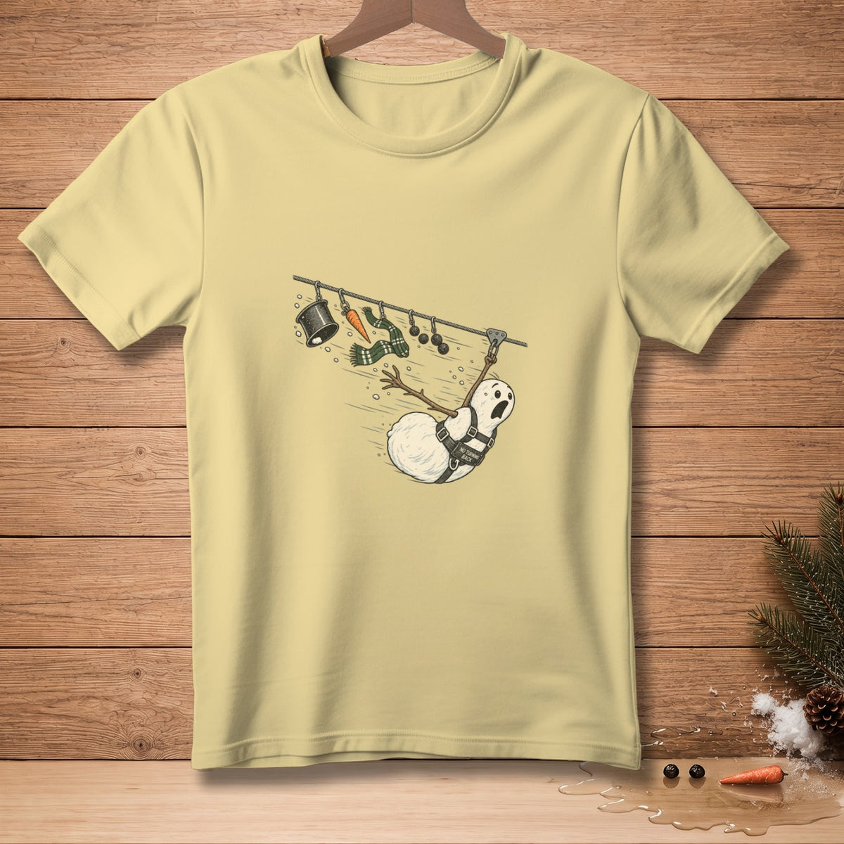 Snowman on a zipline with a carrot, scarf, and bucket hanging above.