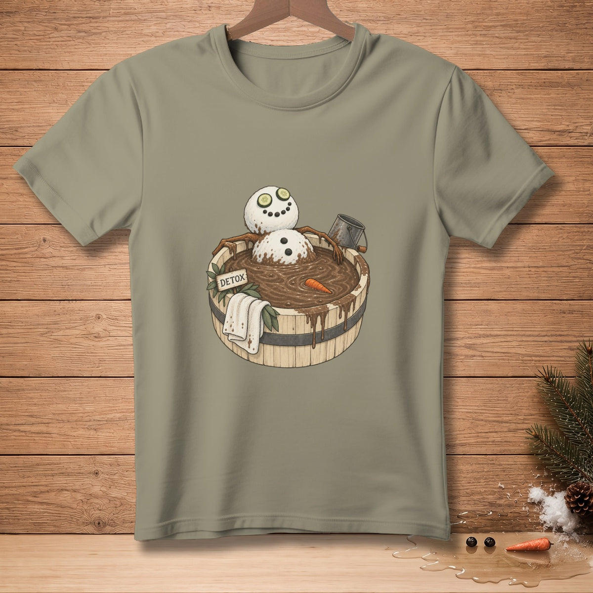 T-shirt graphic of a snowman in a detox mud bath with a carrot and cucumbers.