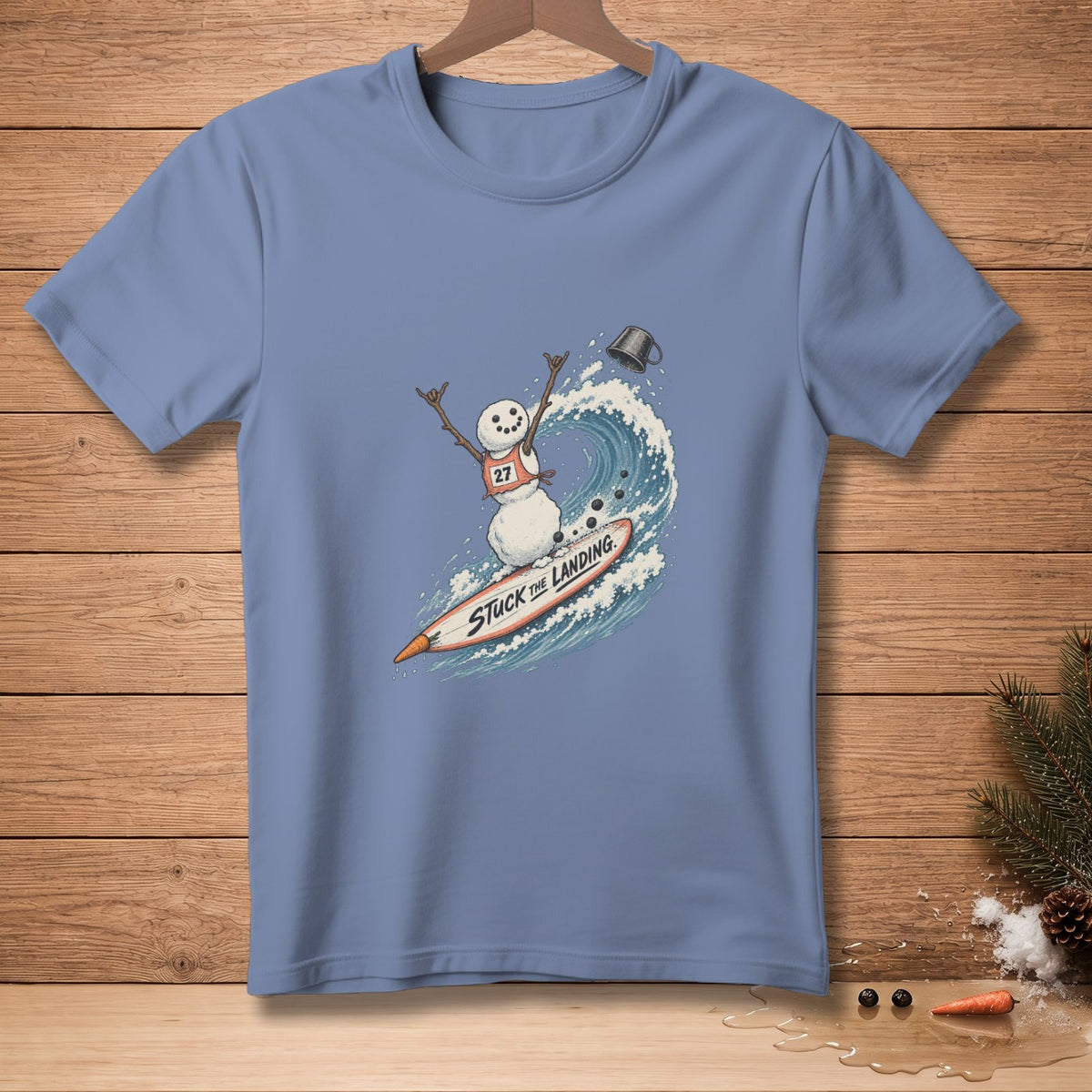Snowman surfing a wave on a surfboard with text "STUCK THE LANDING".