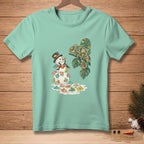 Snowman with cocktail umbrellas melting next to a floral chameleon on a branch.