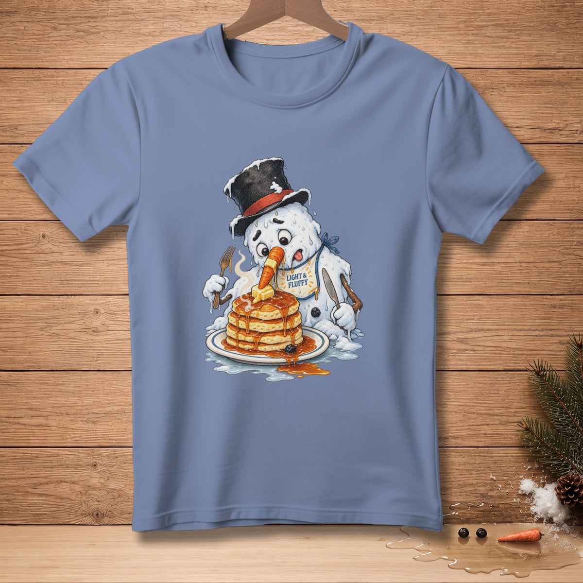 Snowman in top hat eating pancakes with syrup, wearing a bib that says "LIGHT & FLUFFY".