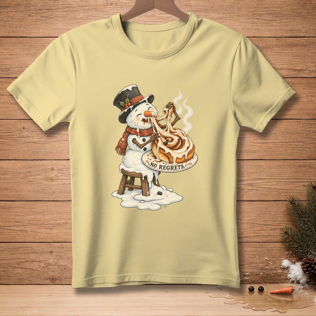 Light yellow t-shirt with snowman melting while eating cinnamon roll, saying "No Regrets".