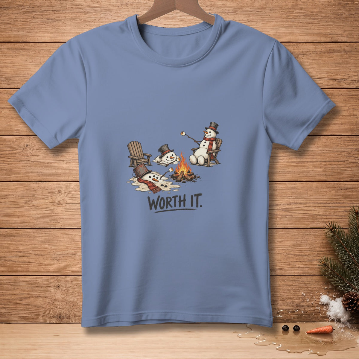 T-shirt with melting snowmen by a campfire, one roasting a marshmallow.