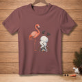 Flamingo standing next to a snowman doing a handstand with boots on.