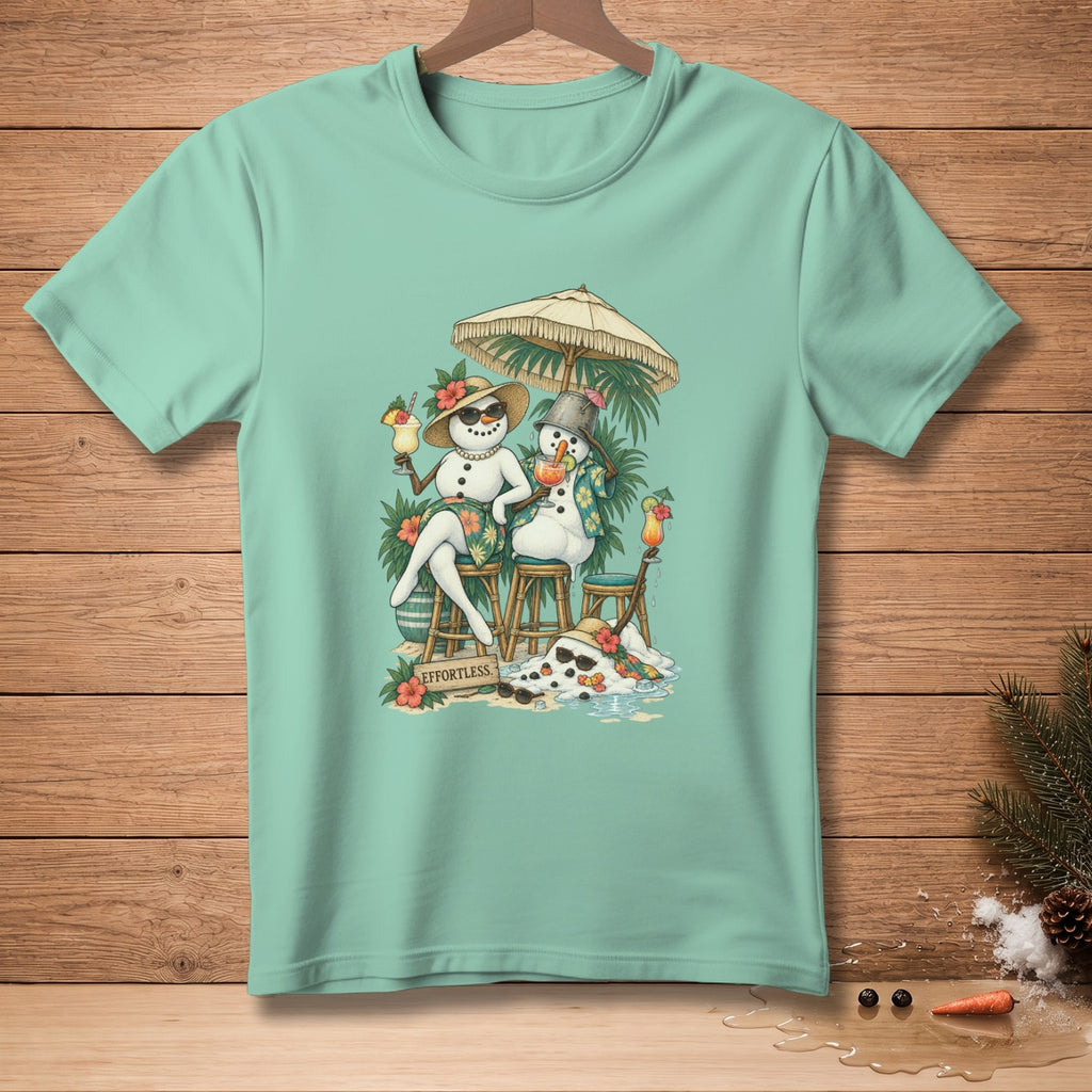 Two snowmen with tropical drinks sit under an umbrella, melting on a beach.