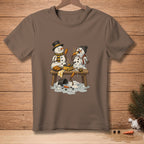 Snowmen melting while trying to cook corn dogs at a picnic table.
