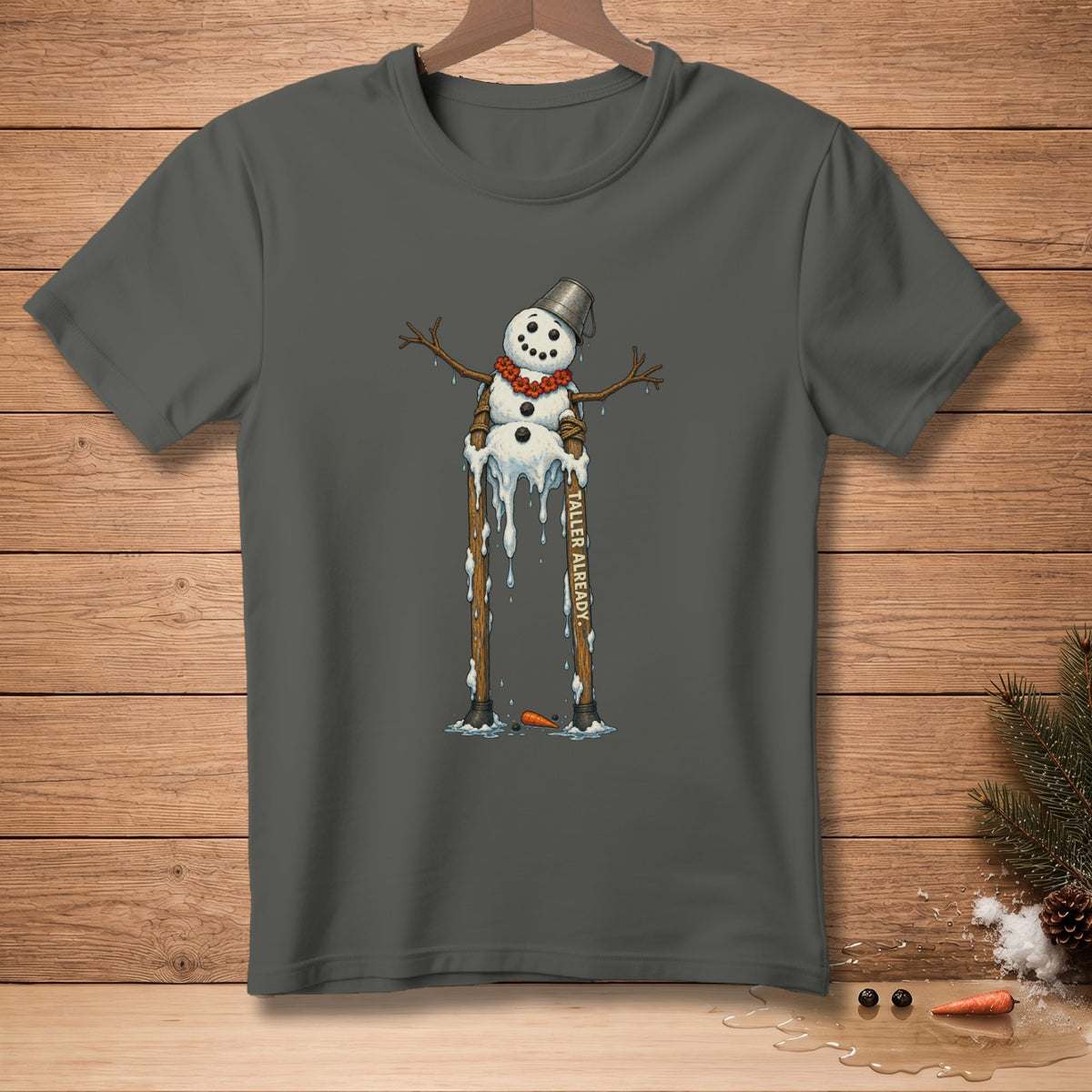 Melting snowman on a dark grey t-shirt with "TALLER ALREADY." text.