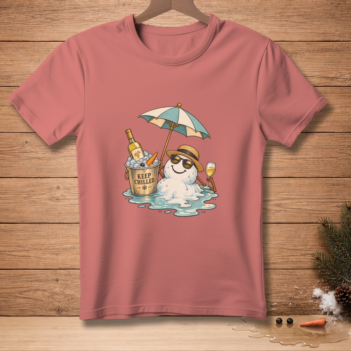 Snowman relaxing with wine, umbrella, and "Keep Chilled" bucket on pink t-shirt.