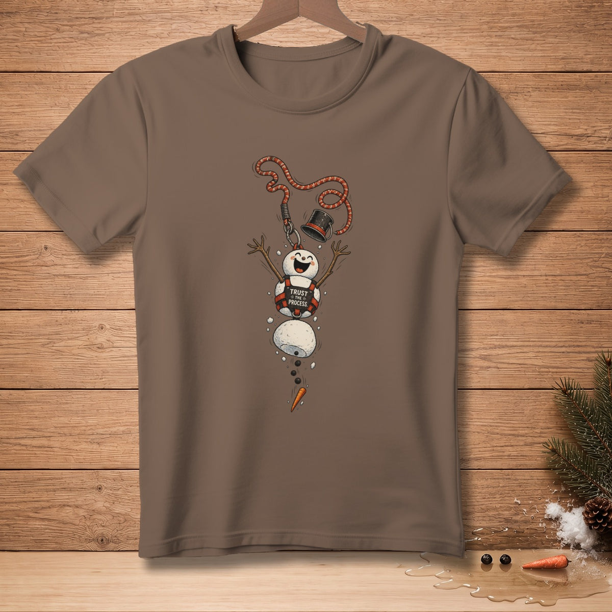 Brown t-shirt featuring a melting snowman with text "TRUST THE PROCESS".