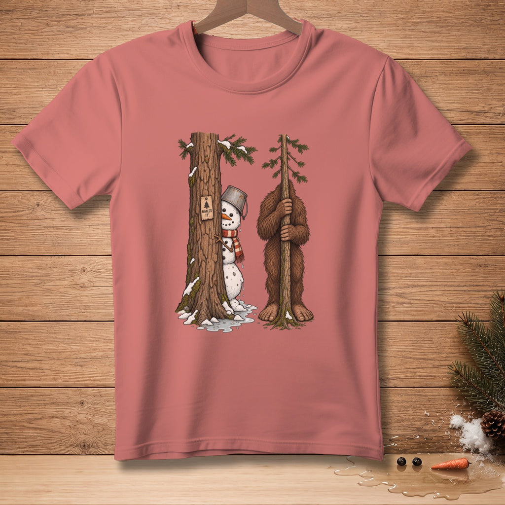 Snowman and Bigfoot peek from behind trees, with "Nailed It." text.