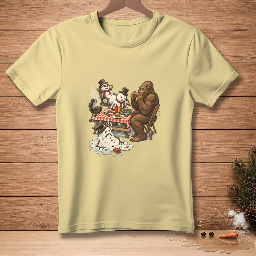 Bigfoot eats a burger with melting snowmen at a picnic table with a grill.