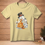 Snowman in a top hat eating a stack of pancakes with syrup.