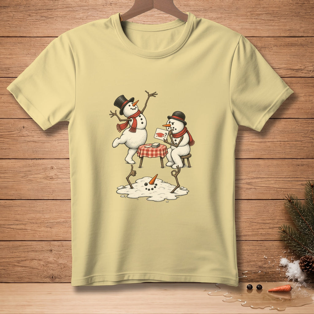 Yellow t-shirt with a drawing of two snowmen and a melting snowman on a table.
