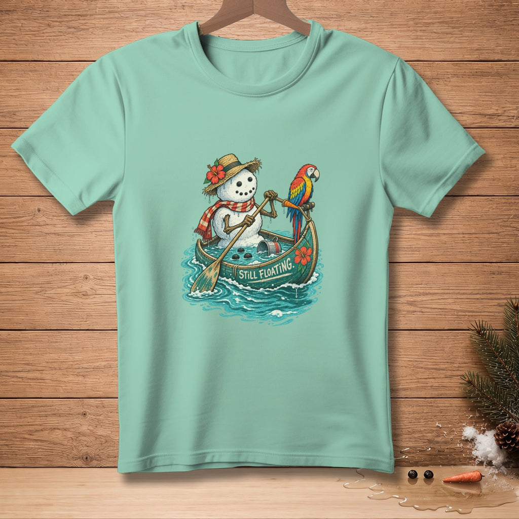 Snowman in a canoe with a parrot, paddles, and text "STILL FLOATING."