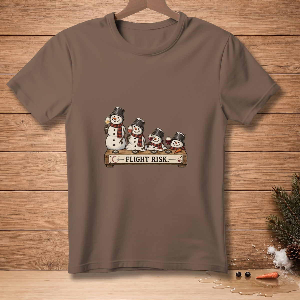 Snowmen with wine glasses and a "FLIGHT RISK" sign on a brown t-shirt.