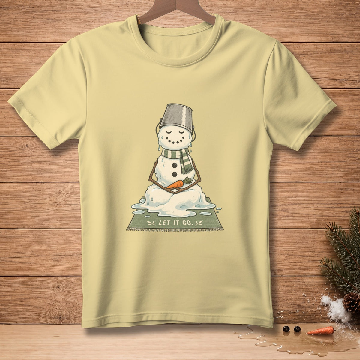 Melting snowman in bucket hat with carrot nose, "LET IT GO." text on shirt.