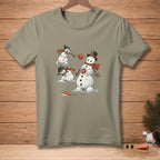 Three snowmen play with red balls on a tan t-shirt.