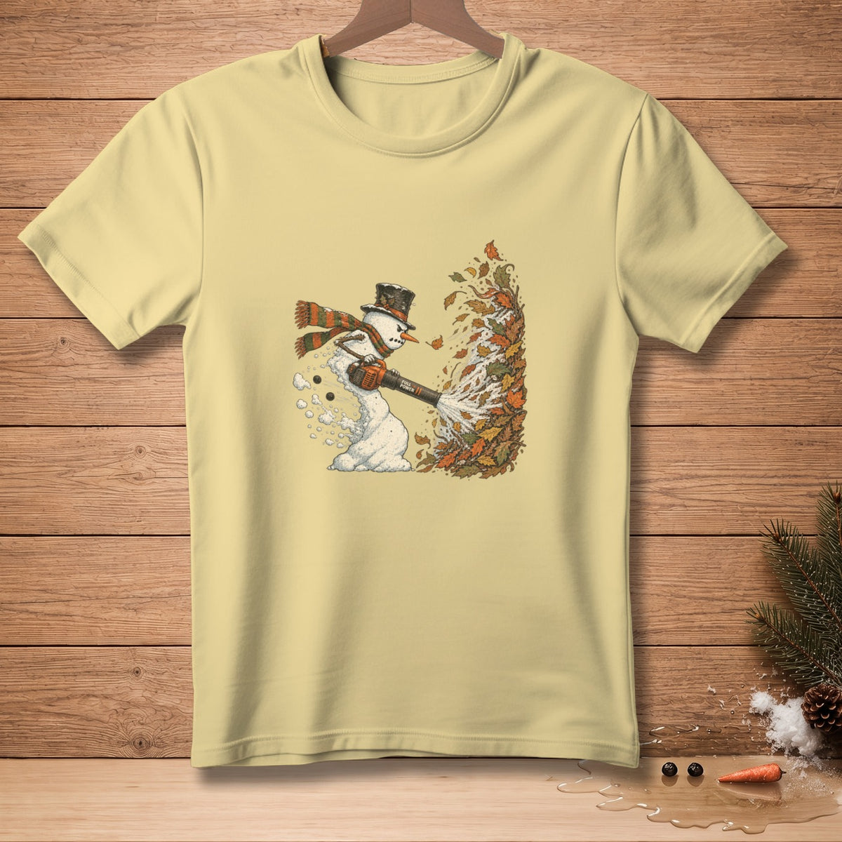Snowman in top hat and scarf uses leaf blower on autumn leaves.
