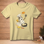 Melting snowman chef flips a pancake with "Worth It" spatula on a light yellow t-shirt.