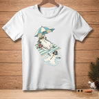T-shirt graphic with melting snowmen on a beach towel under an umbrella.
