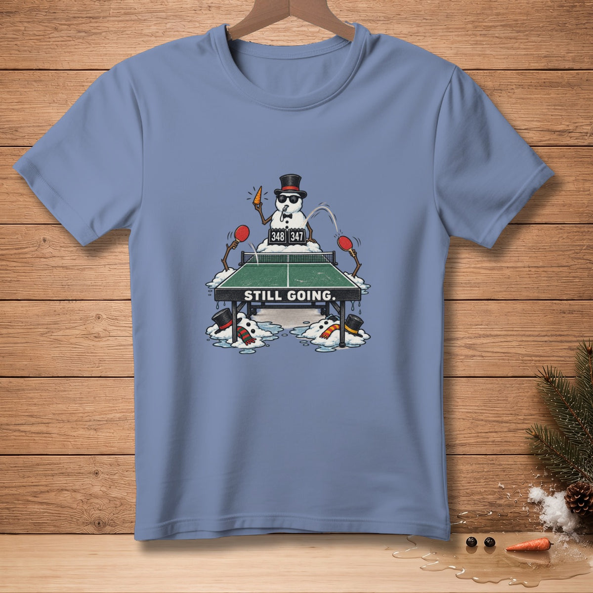 Snowmen playing ping pong on a table with score 348-347 and text "STILL GOING."