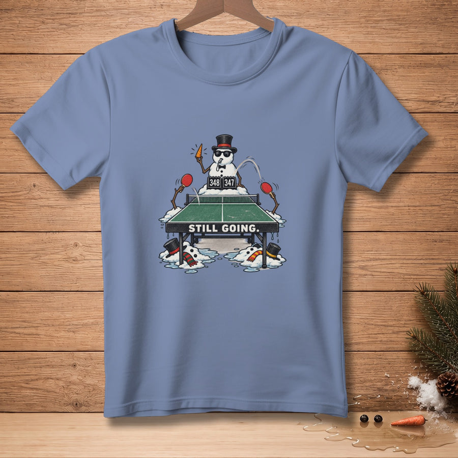 Snowmen playing ping pong on a table with score 348-347 and text "STILL GOING."