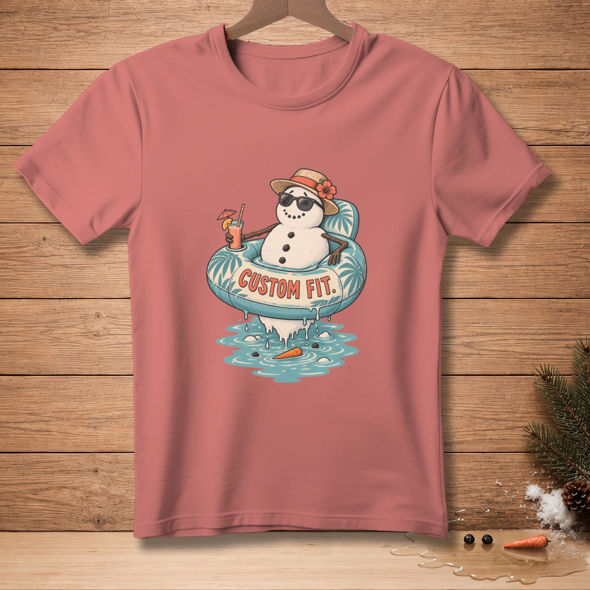 T-shirt with a smiling snowman wearing a hat and sunglasses, floating in a pool with text "CUSTOM FIT".