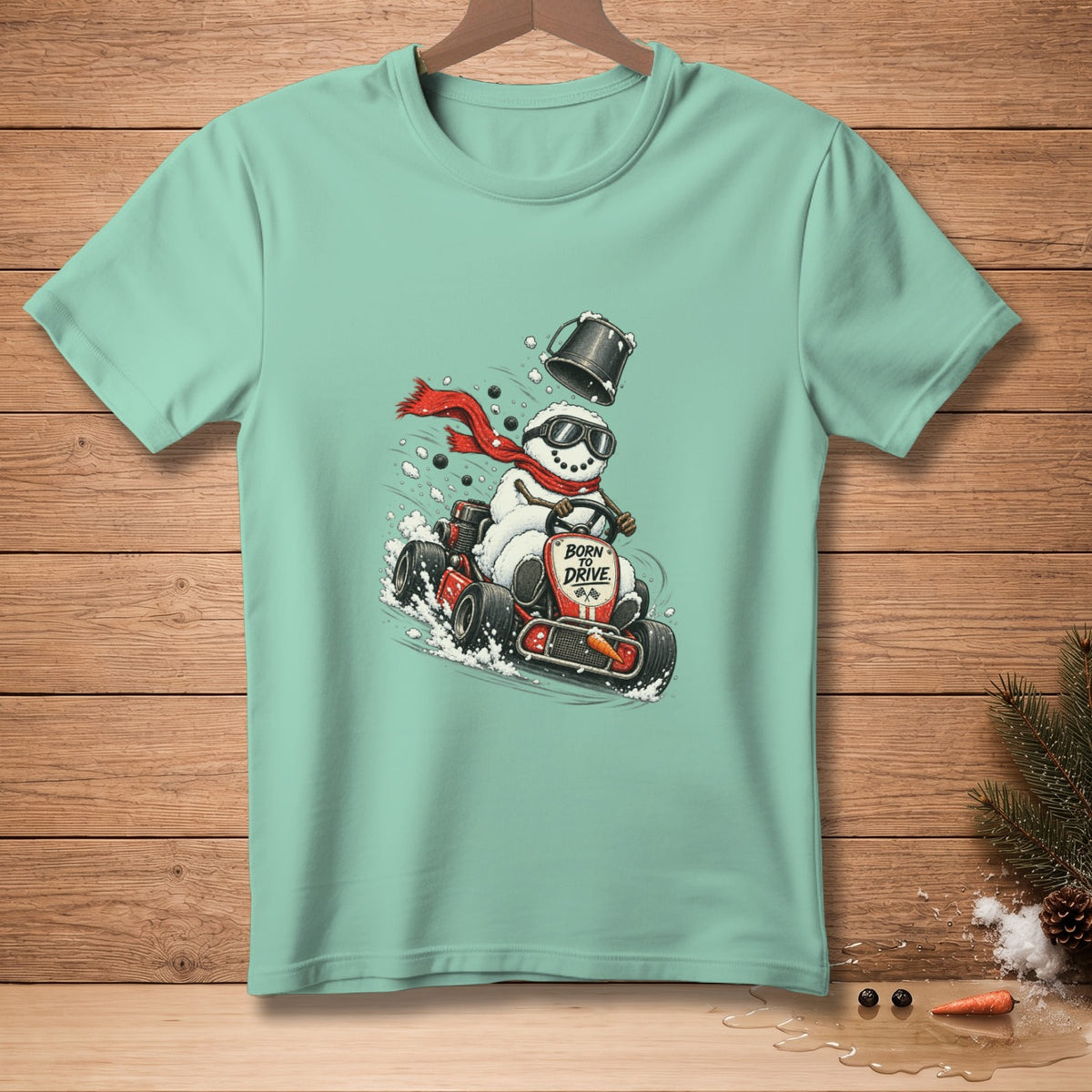 Snowman in go-kart with red scarf, sunglasses, bucket hat, and "BORN TO DRIVE" text.