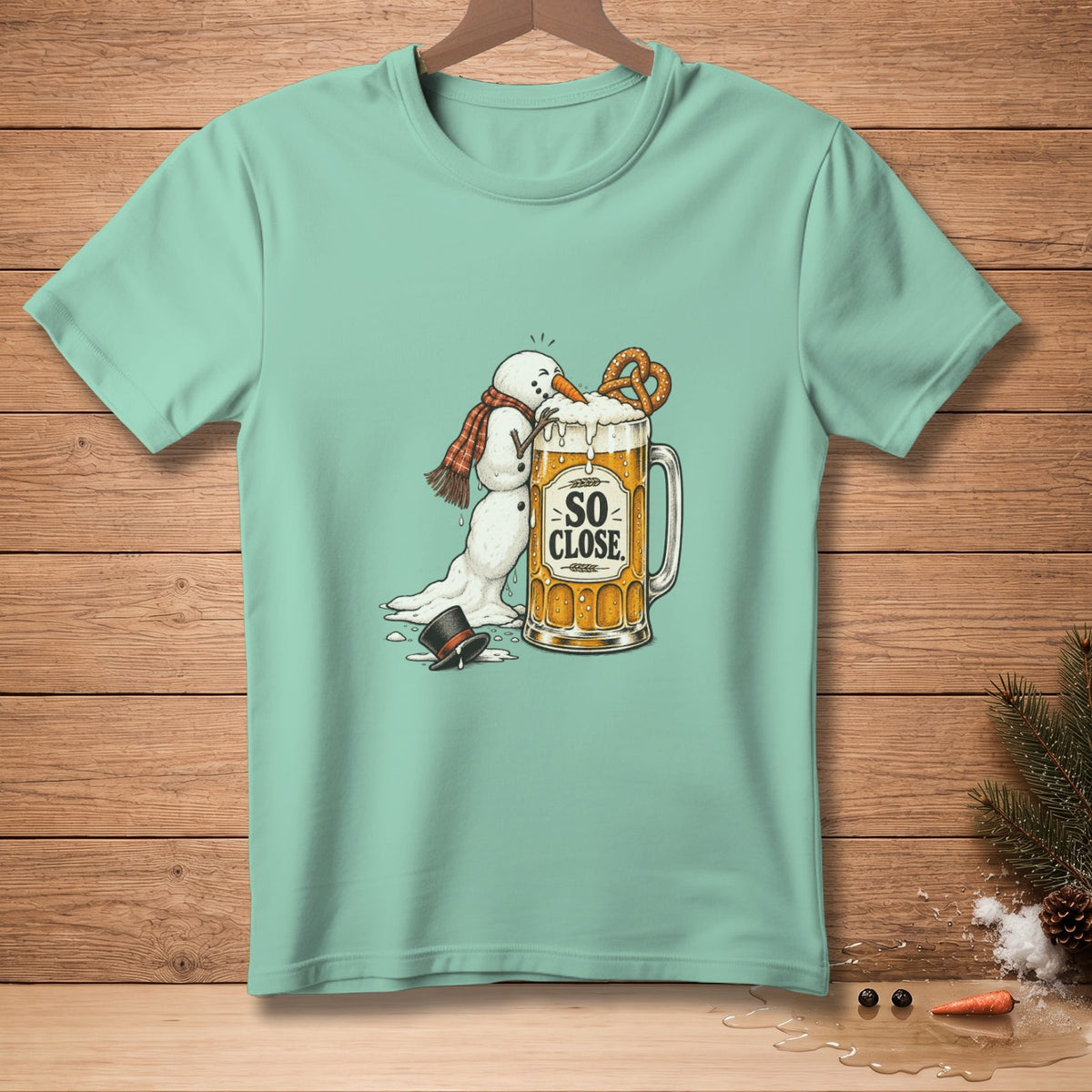 Snowman melting into a beer mug with "SO CLOSE" text and a pretzel.