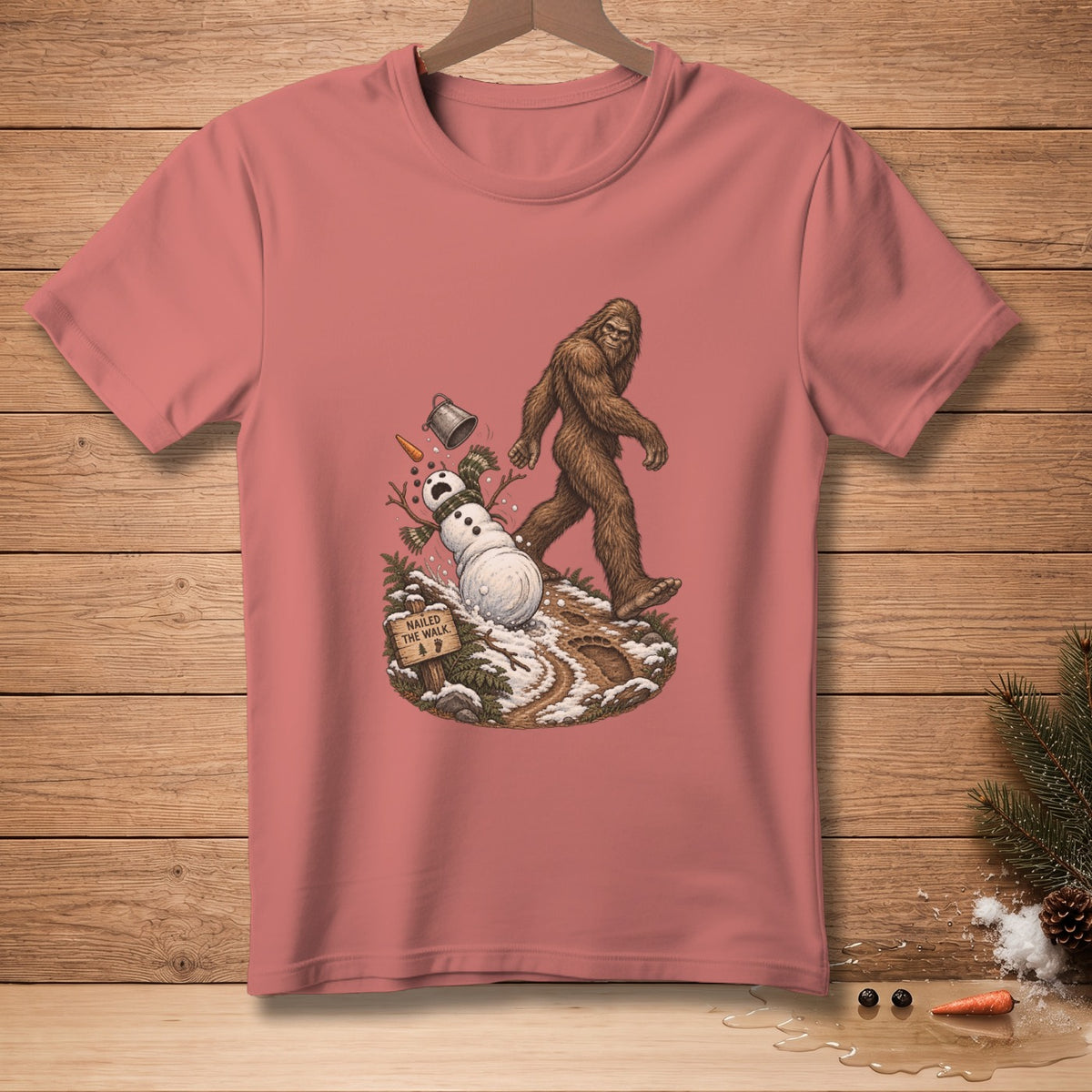 Bigfoot walks past a melting snowman with a "Nailed The Walk" sign.