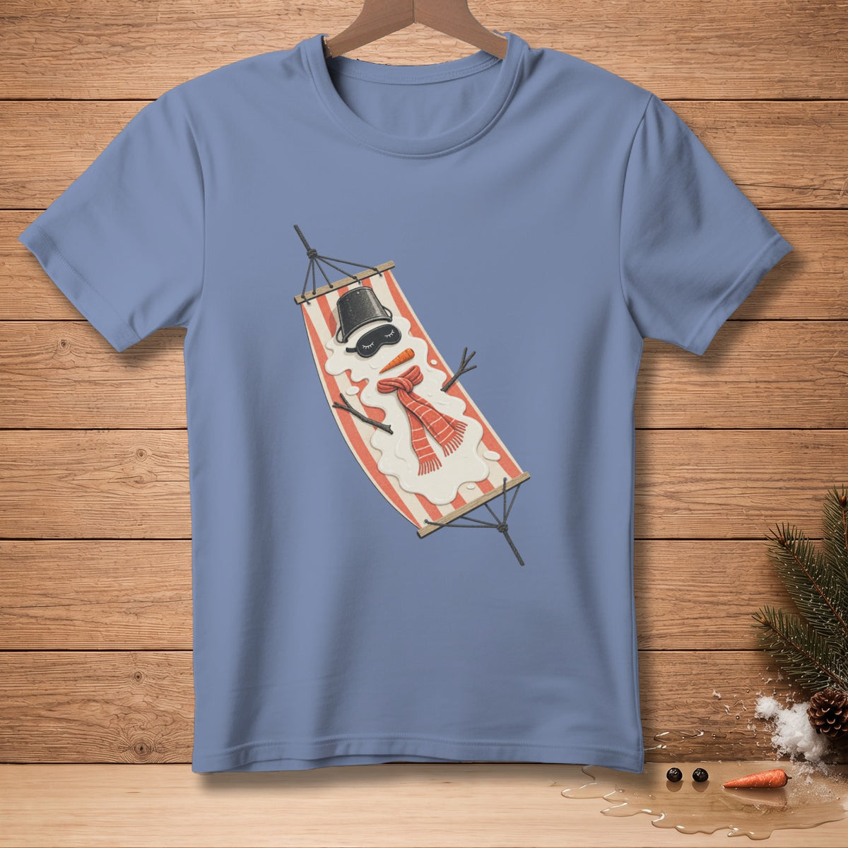 Snowman melting in a hammock with a carrot nose and red scarf.