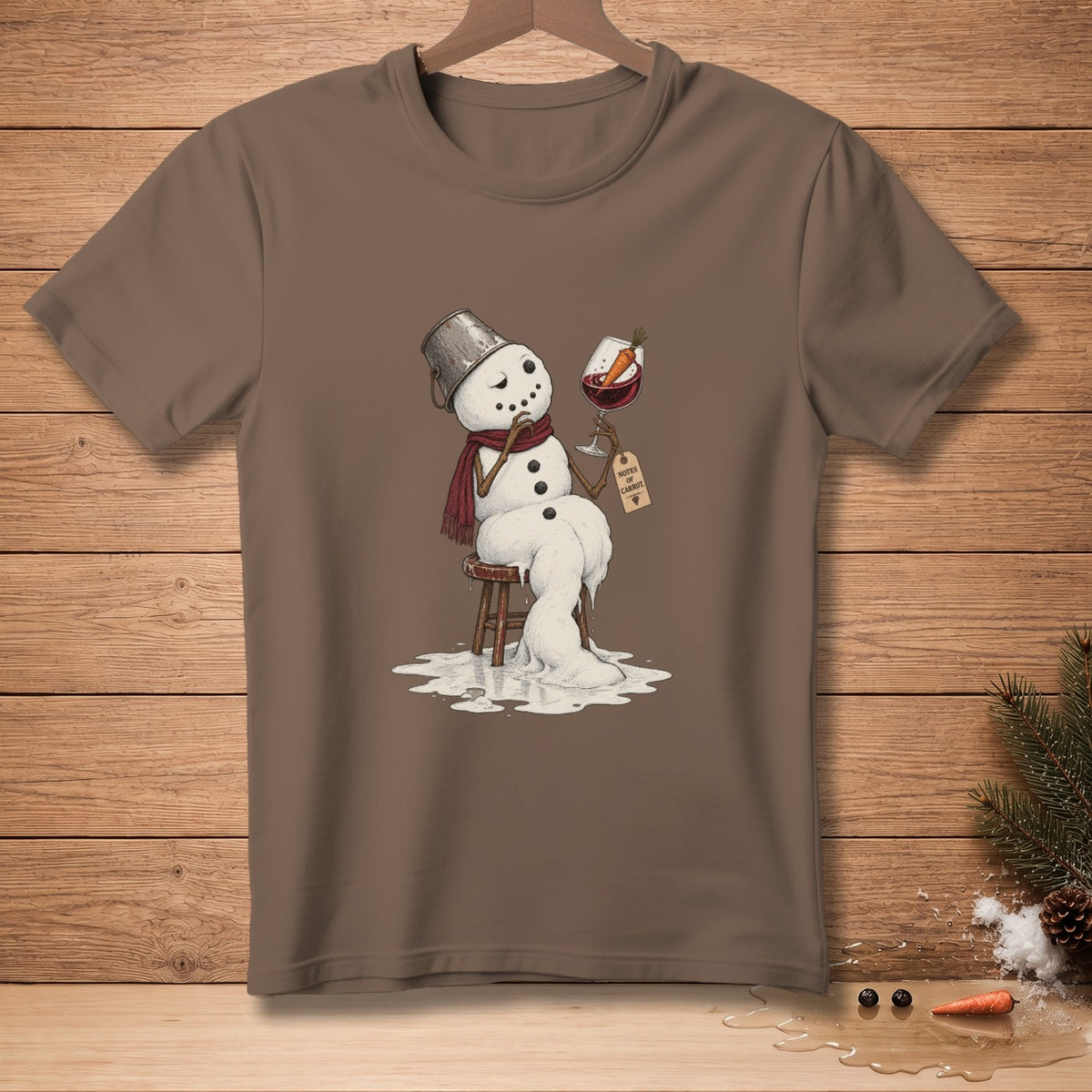 Melting snowman with bucket hat, scarf, and wine, "Notes of Carrot" tag.