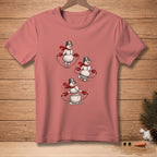T-shirt with three snowmen jumping rope wearing scarves and bucket hats.