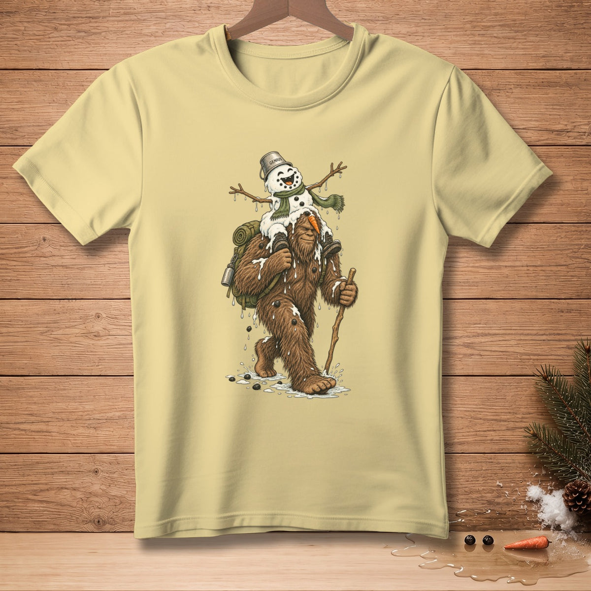 Bigfoot carrying a melting snowman with a bucket that says "Genius".