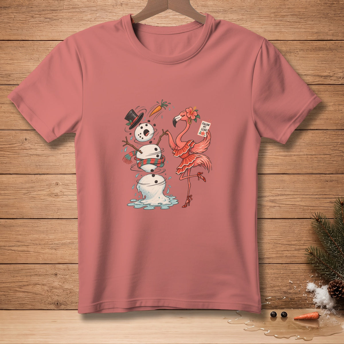 Pink t-shirt with melting snowman and flamingo holding "Follow My Lead" sign.