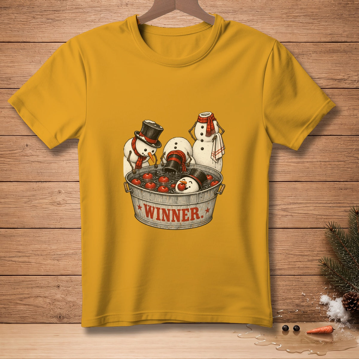 Yellow t-shirt with snowmen bobbing for apples in a bucket labeled "WINNER".