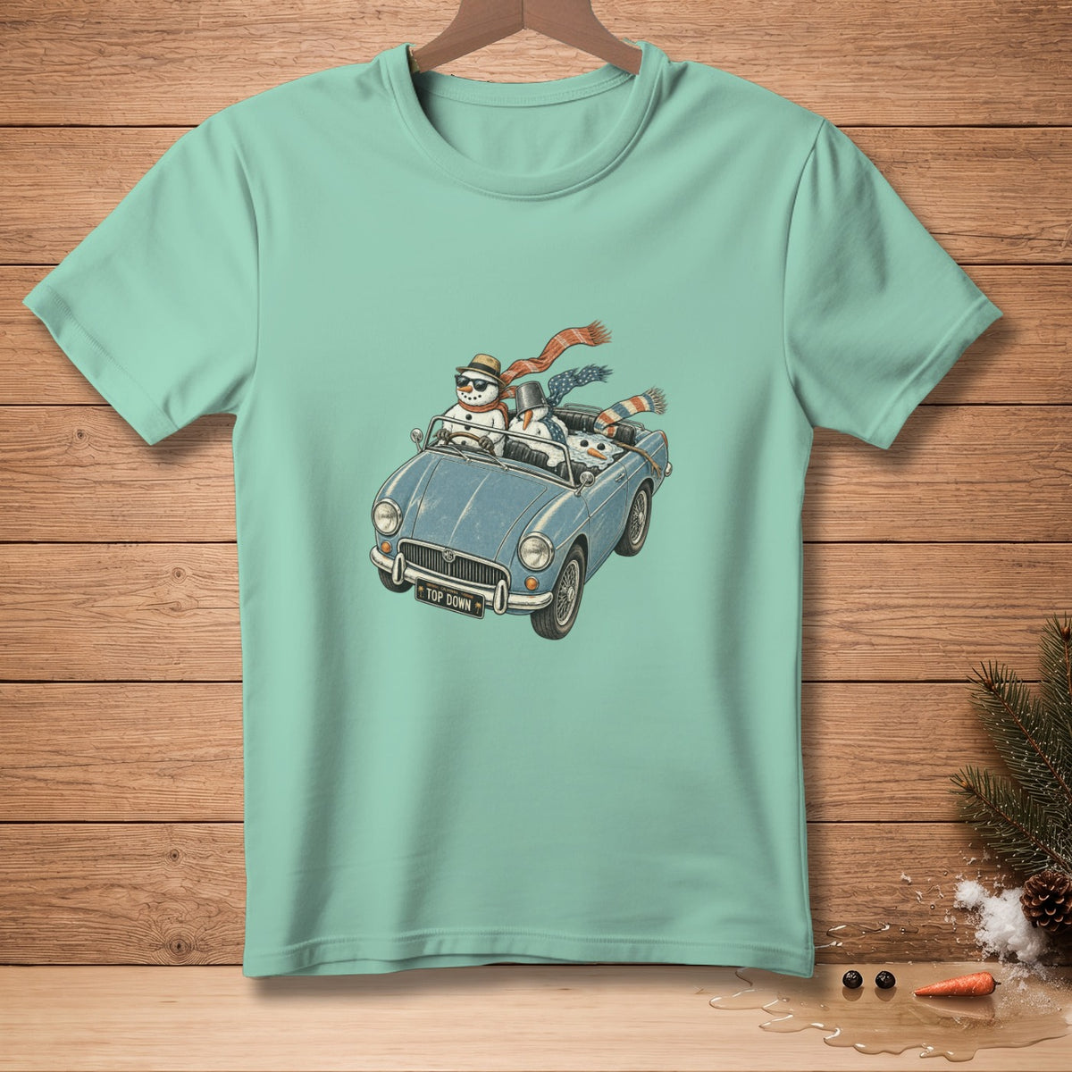 Snowmen wearing scarves and hats drive a blue convertible with "TOP DOWN" license plate.